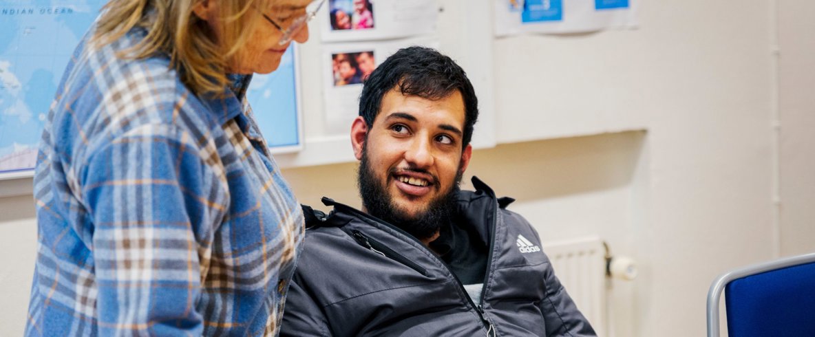 Tre personer promenerar och pratar med varandra.