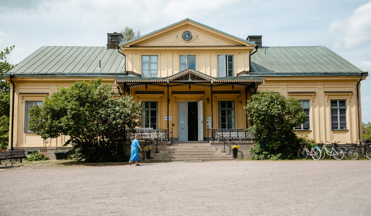 Person som går in på Valla Folkhögskola. 